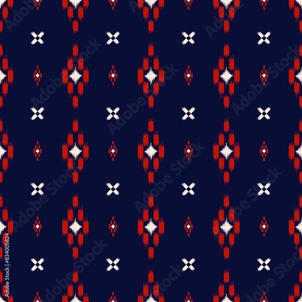 Fototapeta geometric pattern that is reminiscent of traditional Ikat designs. The pattern has a dark navy blue background with red and white