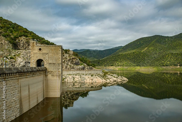 Obraz Dam reflection on a calm reservoir.