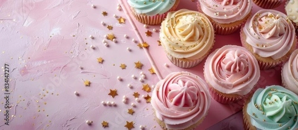 Fototapeta Pink table with cupcakes and notebook