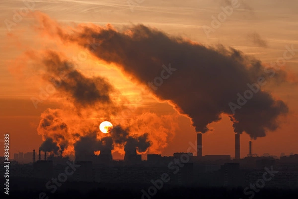 Obraz Sunset through the smoke and steam cogeneration station