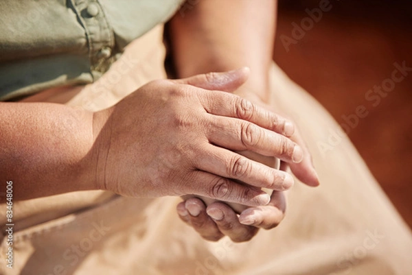 Fototapeta Close up of unrecognizable woman rolling clay ball in hands enjoying art class in sunlit pottery studio copy space