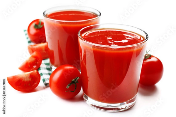 Obraz Glasses of fresh tomato juice on checkered napkin, isolated on white