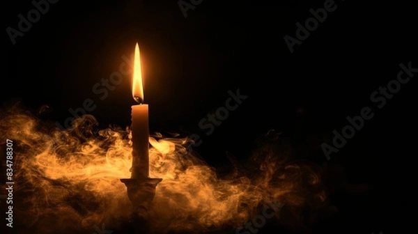 Fototapeta A candle is lit in a dark room with smoke and steam