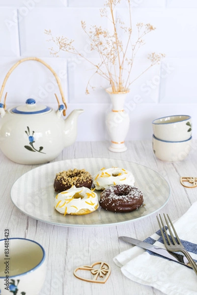 Obraz Dish with homemade donuts on a decorated tea table. Snack concept.