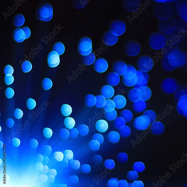 Fototapeta Festive blue and black background with boke and blue light in the corner