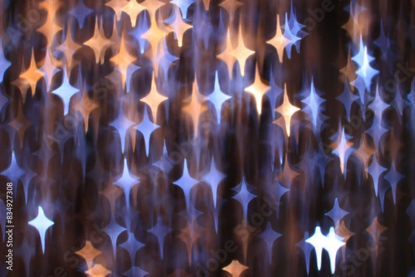 Fototapeta Abstract fuzzy dark background with golden and blue glowing stars
