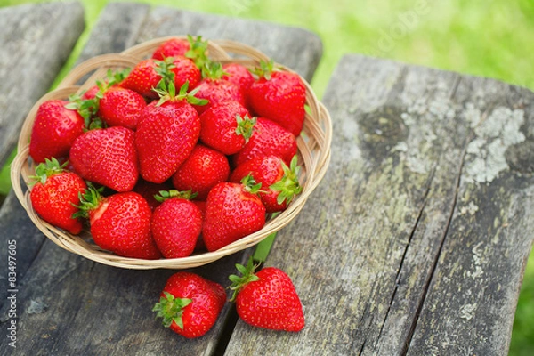 Fototapeta basket with strawberries on a wooden table