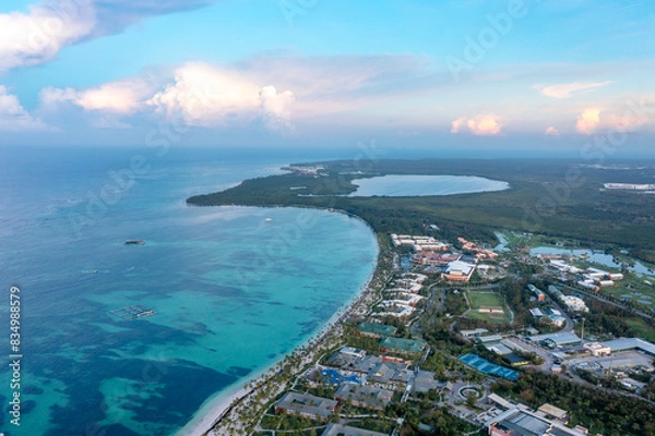 Obraz Drone view Atlantic tropical beach with straw umbrellas, palm trees, hotels. Punta Cana, Dominicana.