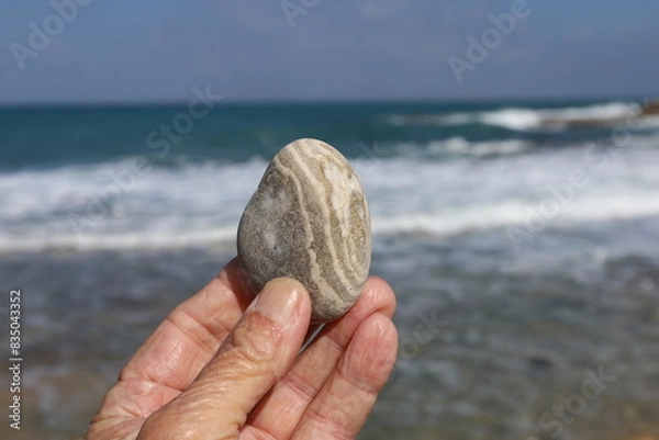 Fototapeta A person's hand holds objects close-up.