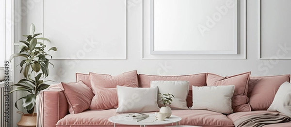 Fototapeta A serene living room with a muted dusty rose sofa and a pristine white frame on the wall, offering tranquility.