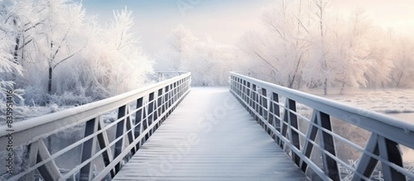Fototapeta Wooden bridge in perspective The bridge is covered with hoarfrost. Creative banner. Copyspace image