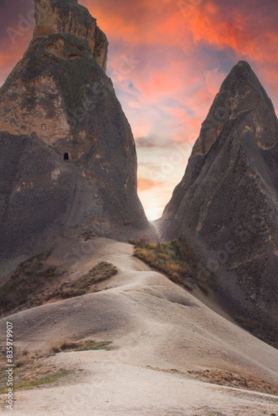 Obraz Beautiful fabulous landscape, dramatic sky. The road through the mountains with caves leading to the light. Strange and amazing views.