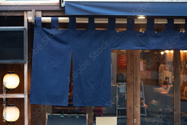 Fototapeta The curtain-like fabric that hangs in front of traditional Japanese restaurants and shops not only serves as a signboard, but holds a larger meaning,