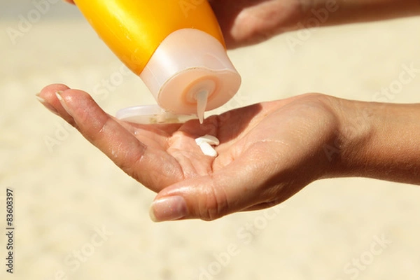 Obraz women squeezing suncream