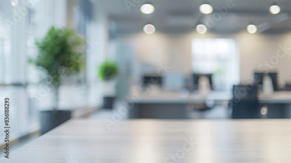 Obraz Blurred office background with empty desk. Modern, bright office setting out of focus with empty desk space in the foreground, perfect for product placement or background use.
