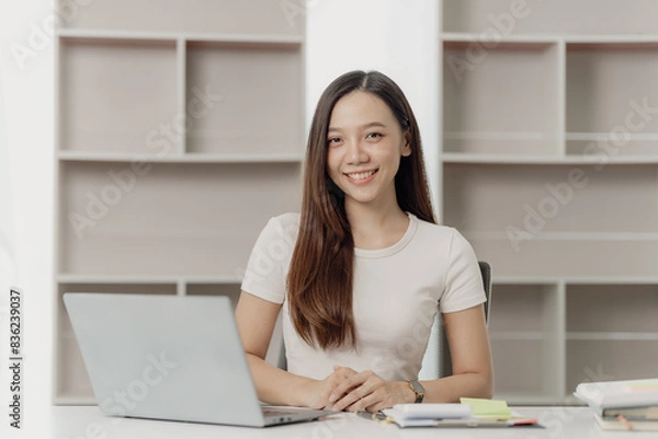 Fototapeta Businesswoman working on financial documents on the desk in the office is writing notes and calculating income and expenses.