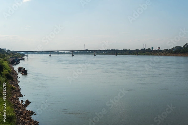 Obraz A river with a bridge in the background