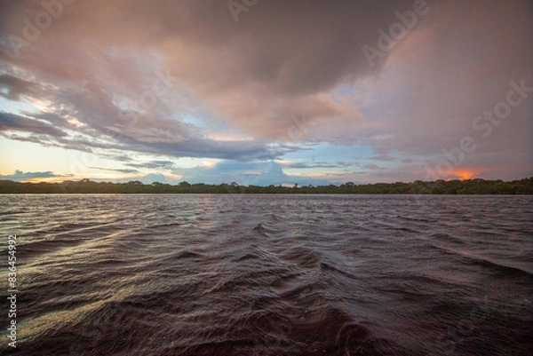 Fototapeta A beautiful rainbow at dusk on the Rio Negro, in the Anavilhanas river archipelago, in the Brazilian Amazon rainforest. The beauties of nature.