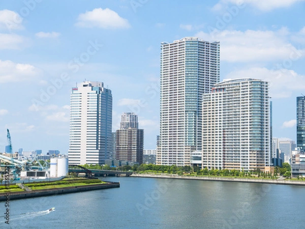 Obraz building and cranes under construction against blue sky