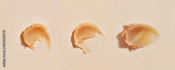 Fototapeta Three cosmetic scrub texture swatches. Exfoliating cream with abrasive sugar or salt particles.