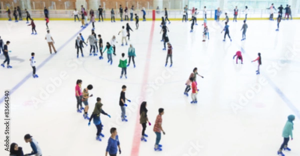 Fototapeta Defocused of indoor ice skating park with skating people.