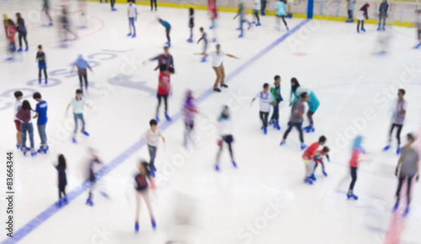 Fototapeta Defocused of indoor ice skating park with skating people.