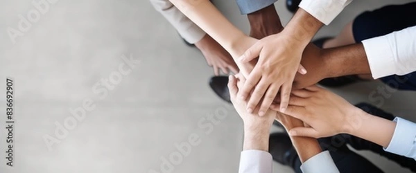 Fototapeta Top view of business people hands together in team unity and support on grey background with copy space. High quality, professional photo, sharp focus, high resolution, shot in the style of Canon EOS.
