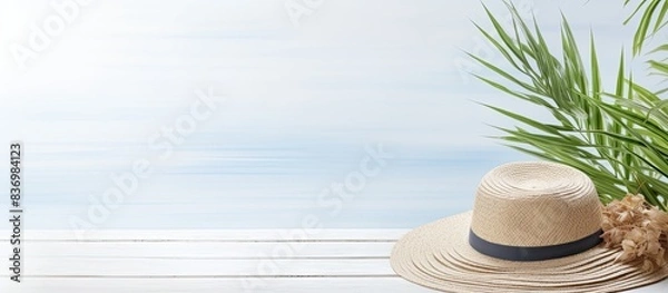 Fototapeta Copy space image with beach accessories on a white wooden table creates a summery vacation backdrop.