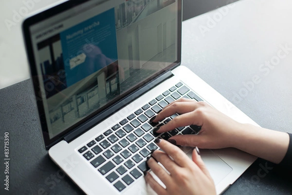 Obraz Shot of a young woman working with laptop, woman's hands using