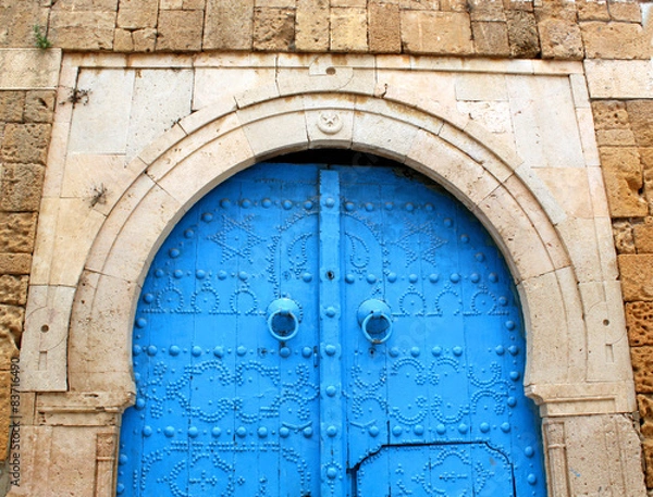 Obraz Blue gate in the stone wall