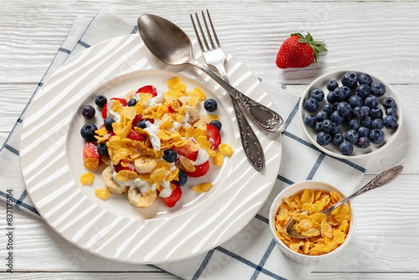 Obraz fresh berries, banana with corn flakes and yogurt