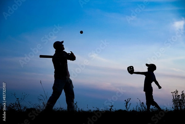 Fototapeta A Happy child with parent playing baseball concept in park in nature
