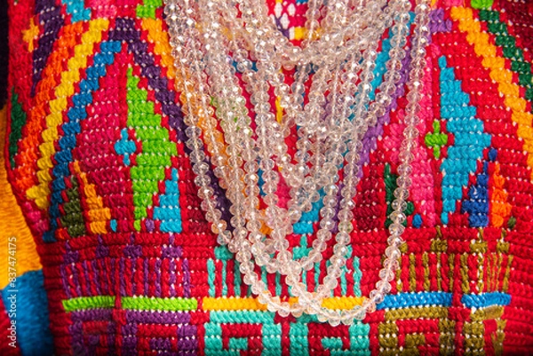 Fototapeta A colorful necklace with a clear chain is displayed on a colorful background