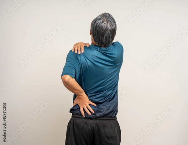 Fototapeta Senior asian old man with sportswear has an inflamed neck and shoulder pain. Old man senior has problem with structural posture