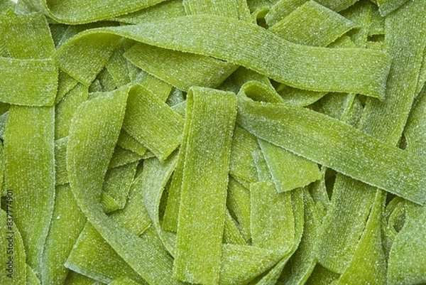 Fototapeta Green sour gummy jelly candy strips in sour apple flavor