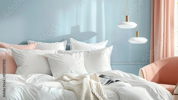 Fototapeta Neatly made bed with a variety of pillows and a throw blanket, set against a light blue wall with a peach-colored curtain on the right side