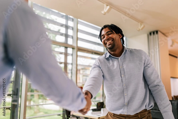 Obraz Human Resource congratulates the new employee of their company after the job interview.