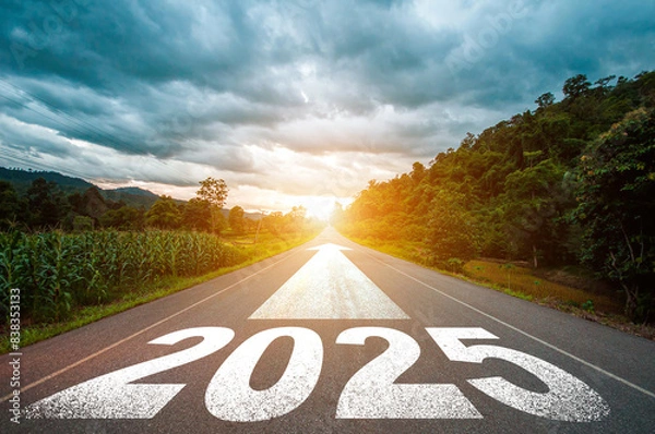 Fototapeta New year 2025 or straight forward concept. Text 2025 written on the road in the middle of asphalt road with at sunset. Concept of planning, goal, challenge, new year resolution.