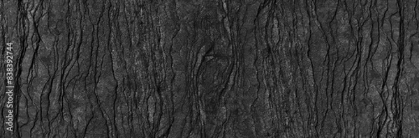 Fototapeta Black rock texture background. Rough mountain surface with cracks. Close-up. Dark gray stone basalt background. Panorama 