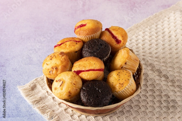 Obraz muffins on a table with books and flowers
