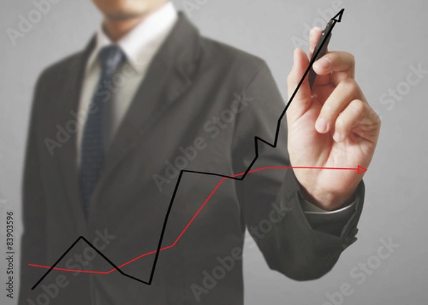 Fototapeta Businessman drawing graphics