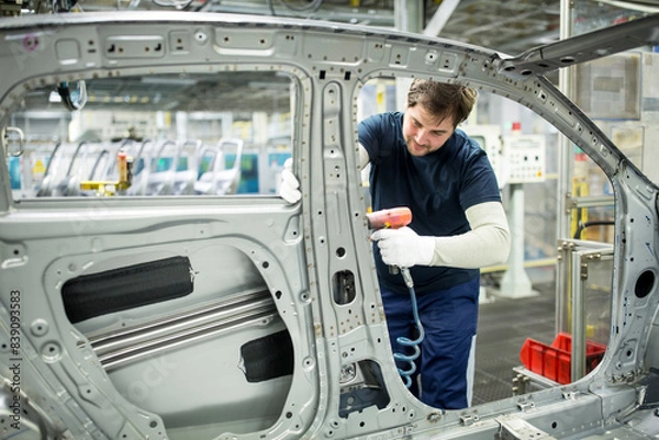 Fototapeta Man working in modern car factory