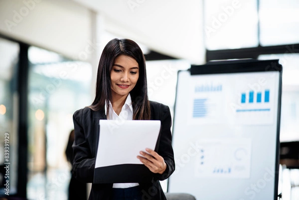 Obraz Professional businesswoman working on laptop and document and calculator about business accounting financial and marketing