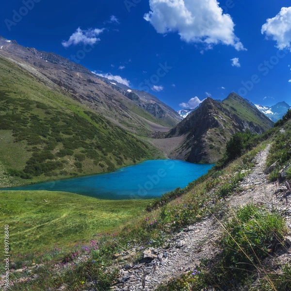 Obraz Lake with clear blue water in the mountains under the sky with clouds in summer