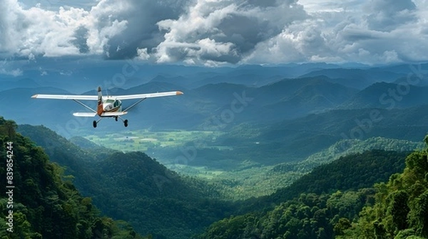 Fototapeta Small Personal Plane Soaring Over Lush Tropical Mountainous Landscape