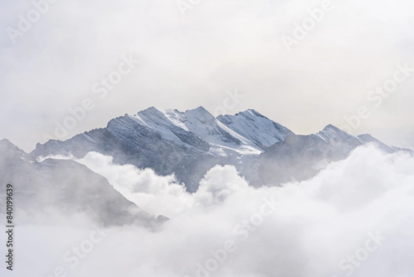 Fototapeta View of Swiss Alps over clouds on a bright sunny day from Schilthorn summit in Switzerland