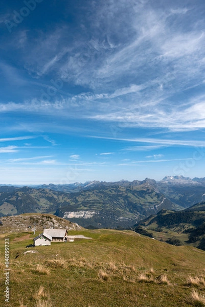 Fototapeta Mountain hut and cable car seen from Fronalpstock summit, Switzerland. Swiss Alps iconic view