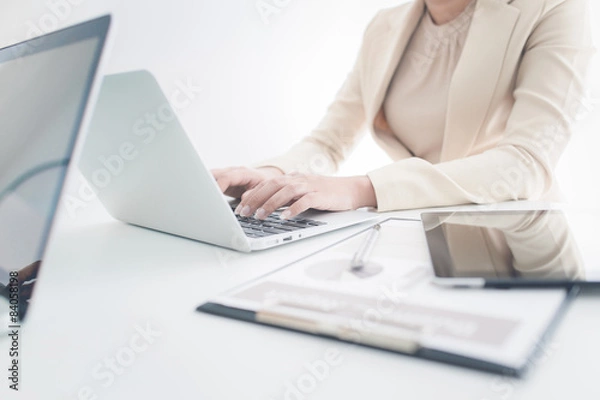 Obraz Unrecognizable business person analyzing graphs and taking notes