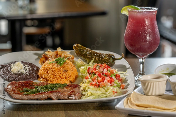 Fototapeta Carne Asada - with Mexican rice, refried pinto beans, and chile toreado. Salsa verde, salsa brava and salsa habanero with Sangria

