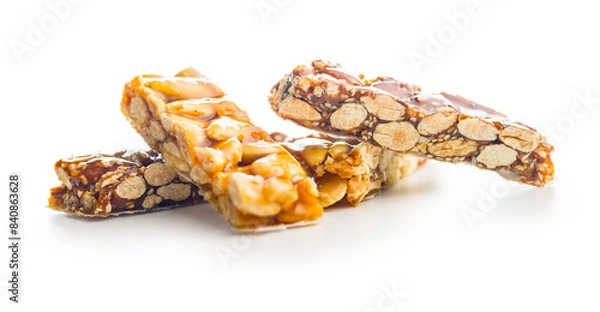 Fototapeta Close Up of almond Brittle Bars With Caramelized Coating isolated on white background.